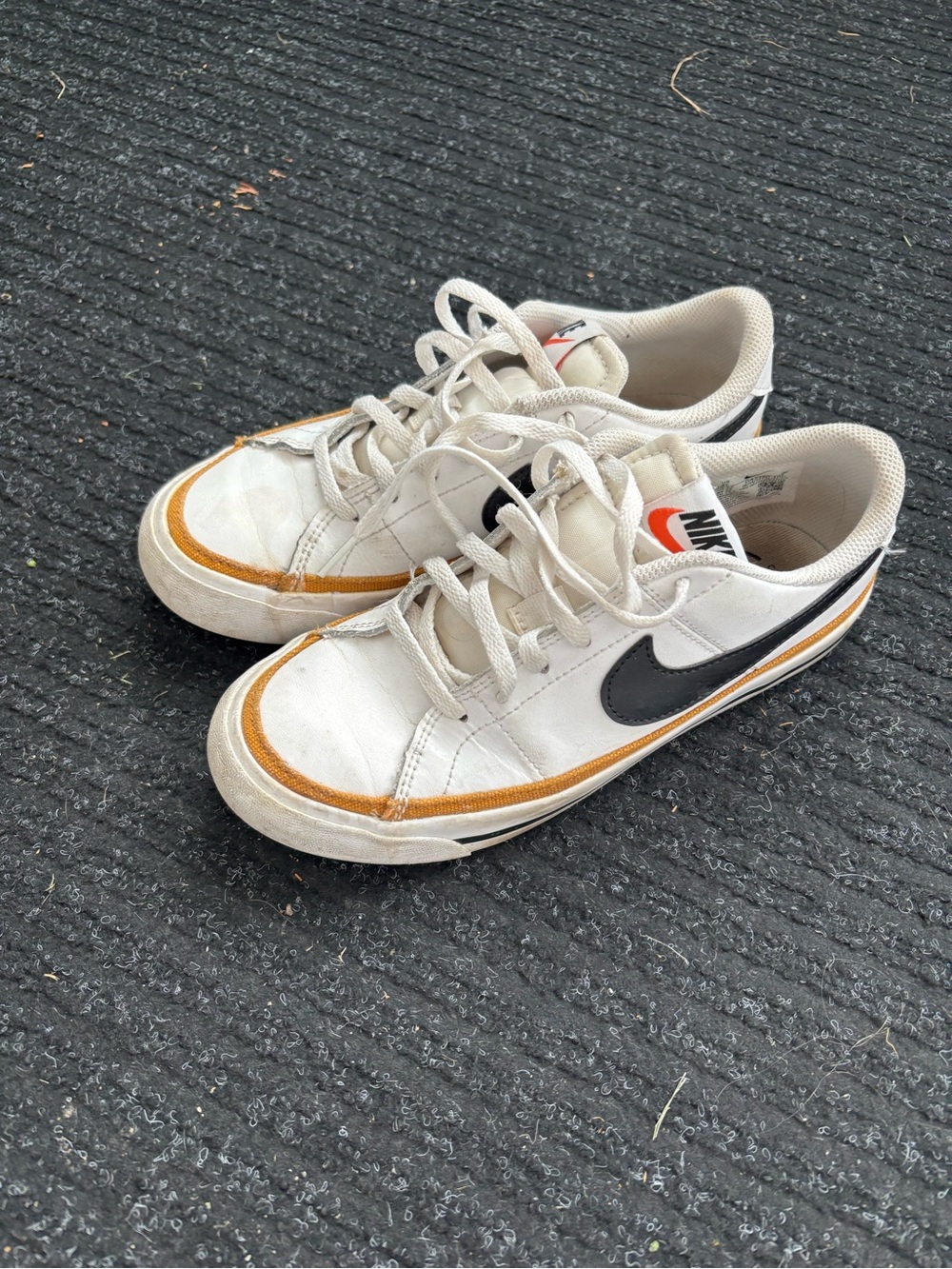 Nike Kids White Sneakers with Black Swoosh and Orange Accent